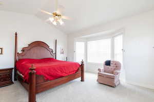 Bedroom featuring light colored carpet, ceiling fan, and lofted ceiling