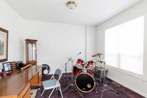 Game room featuring a desk and dark carpet