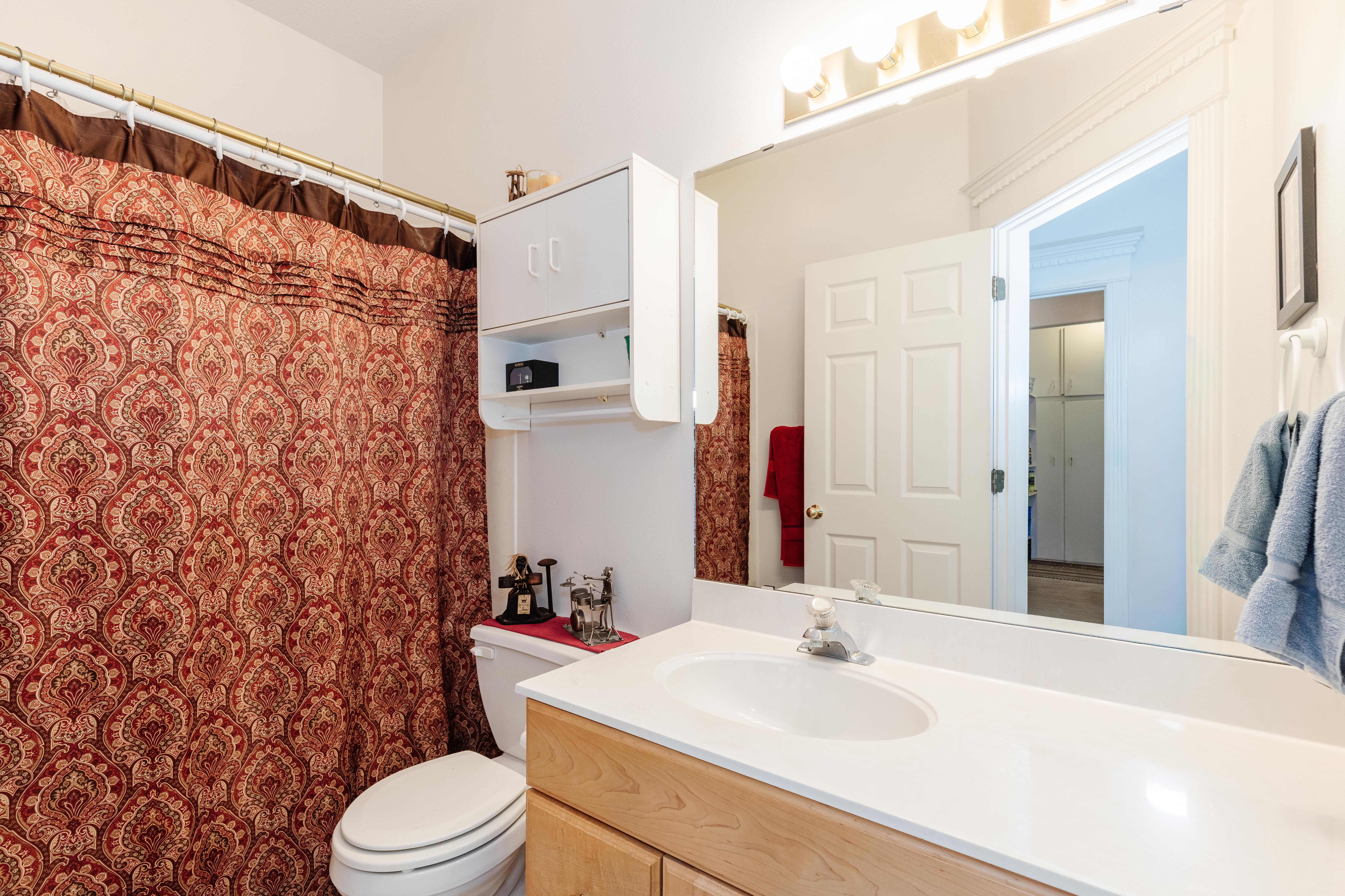 Bathroom featuring vanity and a shower with shower curtain