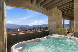 View of swimming pool featuring a hot tub and a mountain view