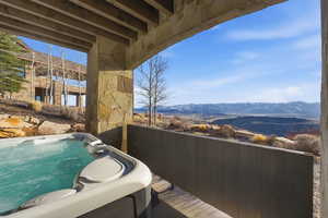 Balcony featuring a mountain view and a hot tub