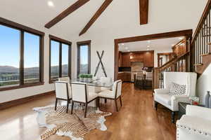 Dining space with wood finished floors, a mountain view, recessed lighting, and lofted ceiling