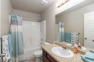 Full bath with vanity and shower / bath combo with shower curtain