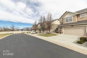 View of asphalt road with a residential view and a mountain view
