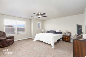 Bedroom with light carpet and ceiling fan