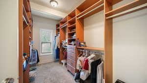 Walk in closet featuring light carpet