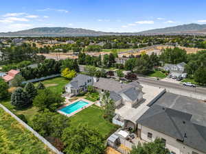 Aerial view of residential area with a mountainous background and a pool area