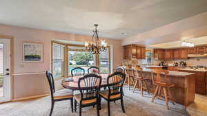 Dining area featuring a chandelier and baseboards