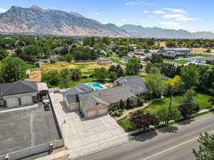 Drone / aerial view of a mountainous background and a pool area