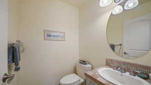 Basement half bath with vanity and toilet