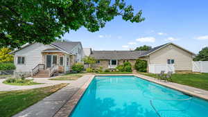 View of swimming pool featuring a fenced backyard, patio surround, and a gate
