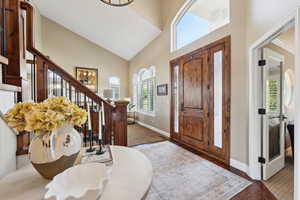 Entryway featuring dark wood finished floors, plenty of natural light, and lofted ceiling