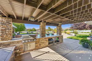 View of patio featuring area for grilling