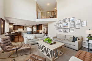 Living area with recessed lighting and a high ceiling