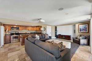 Living room with stone tile flooring and recessed lighting