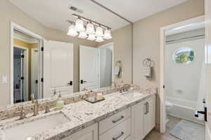 Bathroom featuring double vanity and toilet