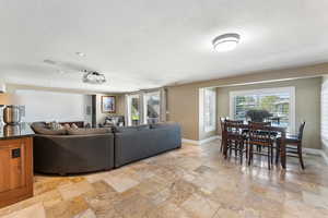 Living room featuring stone tile flooring and recessed lighting