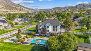 Aerial view of residential area featuring mountains and a pool