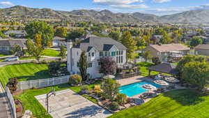 Back of house with a patio, a residential view, a mountain view, and a fenced backyard