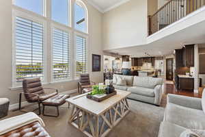 Living area featuring a high ceiling and ornamental molding
