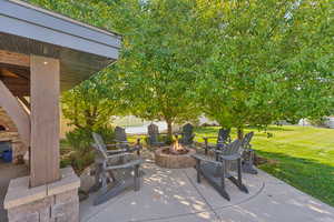 View of patio with a fire pit