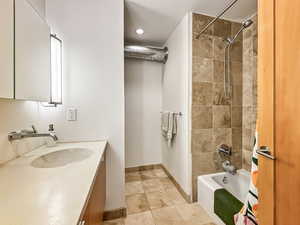 Bathroom with vanity and shower / tub combo