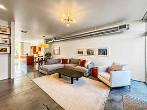 Living room featuring finished concrete flooring