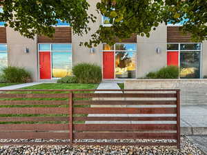 View of exterior entry with stucco siding