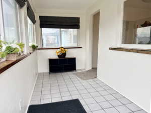 Hallway with light tile patterned flooring