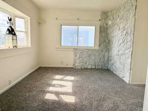 Unfurnished room featuring baseboards and carpet