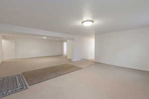 Unfurnished room featuring concrete flooring and baseboards