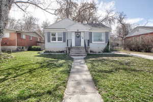 Bungalow-style home featuring a front lawn and brick siding
