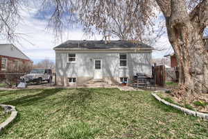 Rear view of property featuring a patio, a gate, brick siding, and entry steps