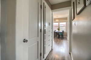 Hallway with baseboards and light wood finished floors