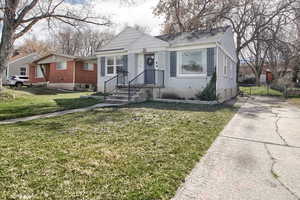 Bungalow featuring brick siding