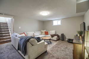 Living room with a textured ceiling and carpet floors