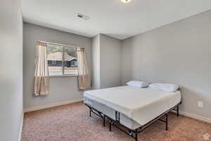 Carpeted bedroom featuring baseboards