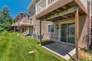 View of green lawn with a patio