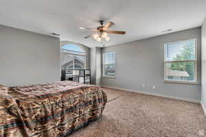 Bedroom featuring light carpet and ceiling fan
