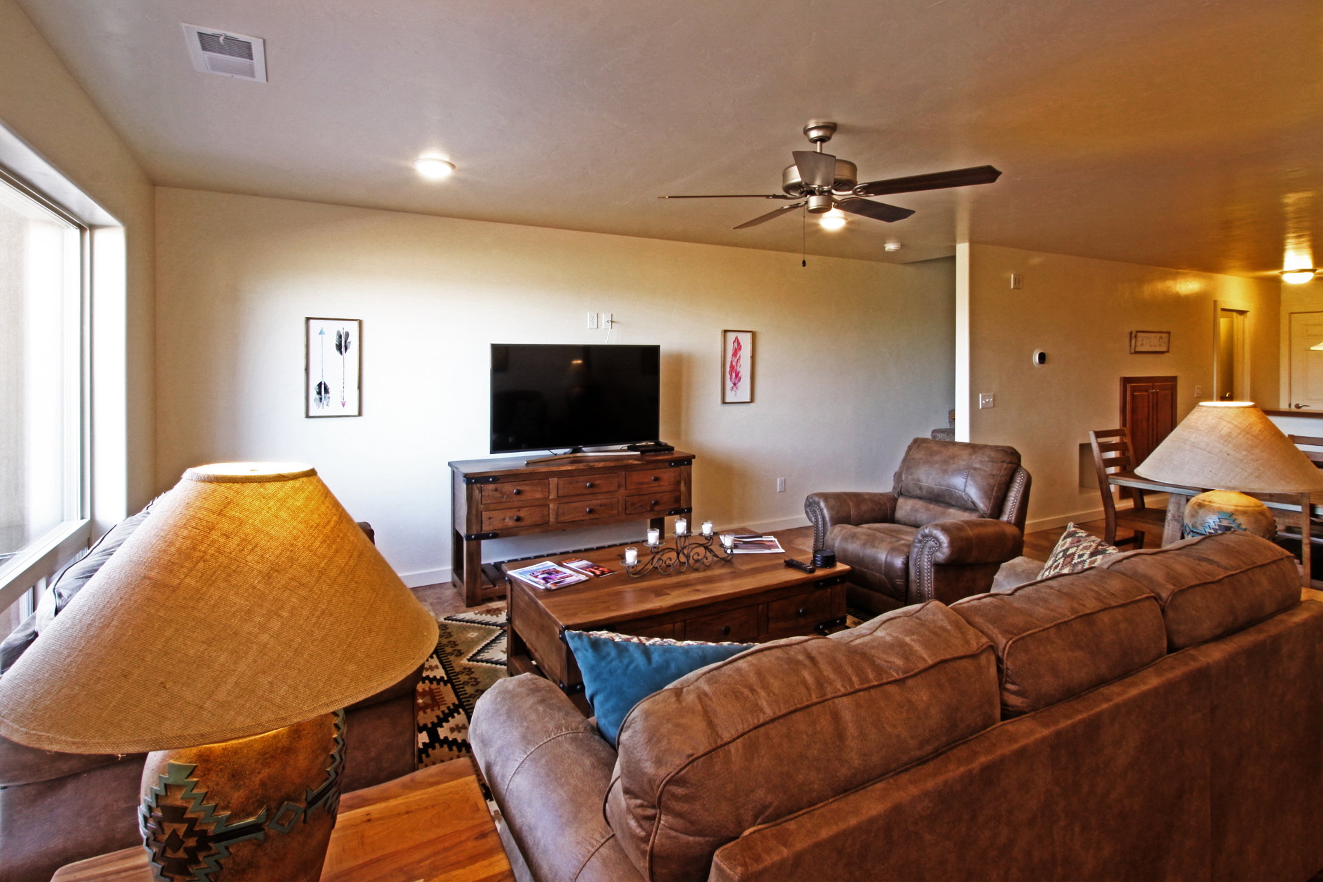 Living room with wood finished floors and a ceiling fan