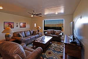 Living room with ceiling fan and wood finished floors