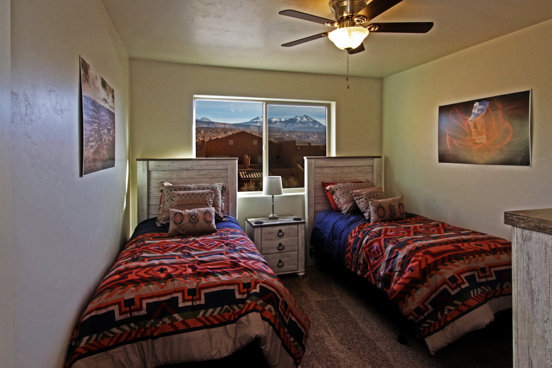 Bedroom featuring dark colored carpet and a ceiling fan