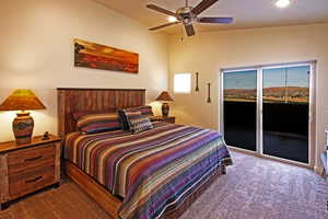 Bedroom with dark carpet, access to outside, and ceiling fan