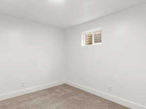 Bedroom #4 featuring baseboards and light carpet