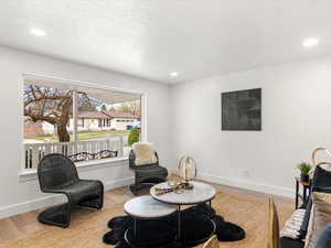 Living area featuring light wood-type flooring and recessed lighting