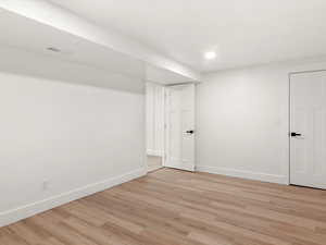 Utility/Storage Room. Finished below grade area with light wood finished floors and recessed lighting