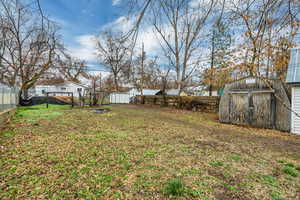 Fenced backyard with a storage unit