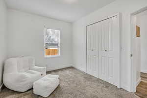 Sitting room with carpet flooring and baseboards