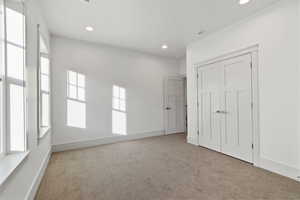 Unfurnished bedroom featuring carpet, a closet, and recessed lighting
