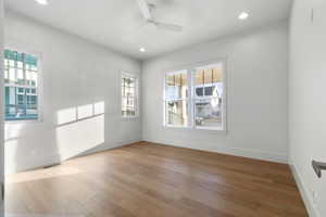 Empty room featuring light wood finished floors, a ceiling fan, and recessed lighting